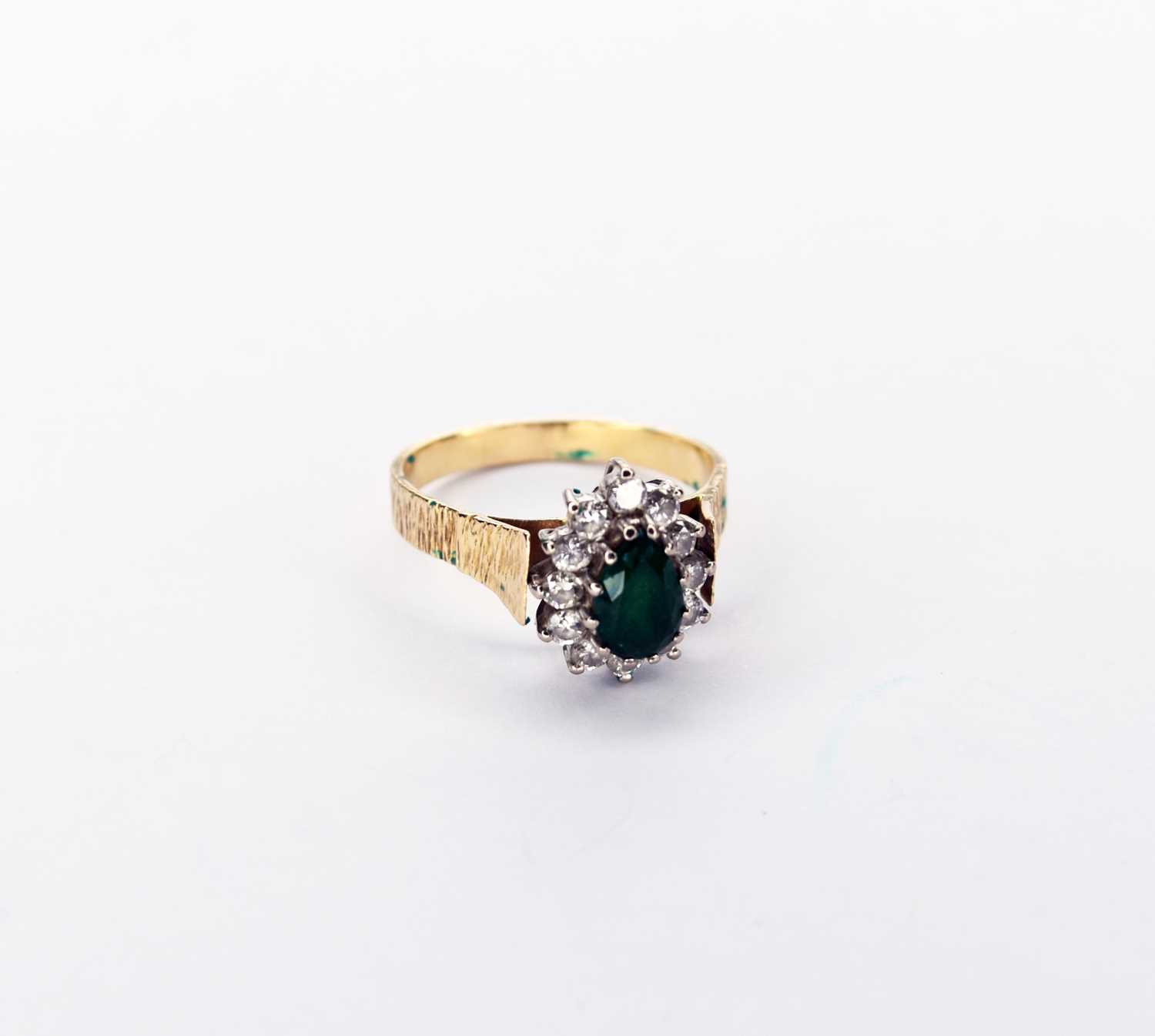 Lot 43 - An emerald and diamond cluster ring