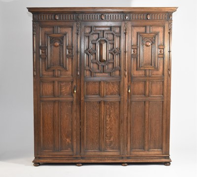 Lot 535 - A 1920s Shapland and Petter of Barnstable, stained oak Jacobean style bedroom suite