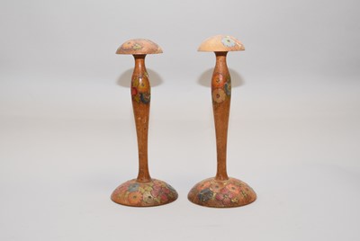 Lot 377 - Two treen poker-work wig stands and a pair of walnut candlesticks