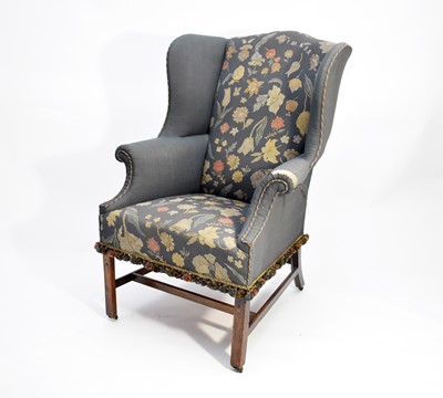 Lot 505 - A George III mahogany upholstered wing armchair