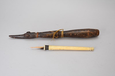 Lot 367 - A Papua New Guinea zoomorphic club and a bone fly whisk handle