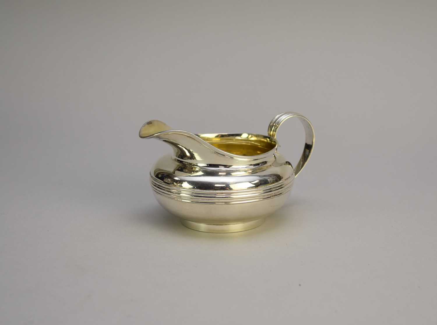 Lot 12 - A George IV silver cream jug