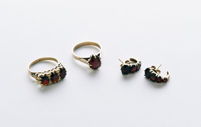 Lot 38 - Two garnet set rings and a pair of earrings