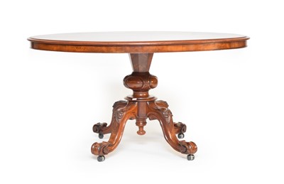 Lot 511 - A late Victorian walnut tilt-top oval breakfast table