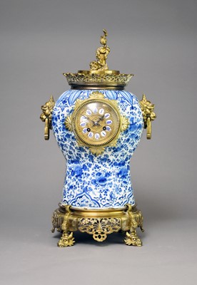 Lot 330 - A Chinese taste brass mounted and Delft mantel clock