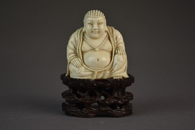 Lot 623 - A Chinese carved ivory Buddha on carved hardwood base