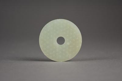 Lot 86 - A Chinese pale green jade bi disc, Ming Dynasty