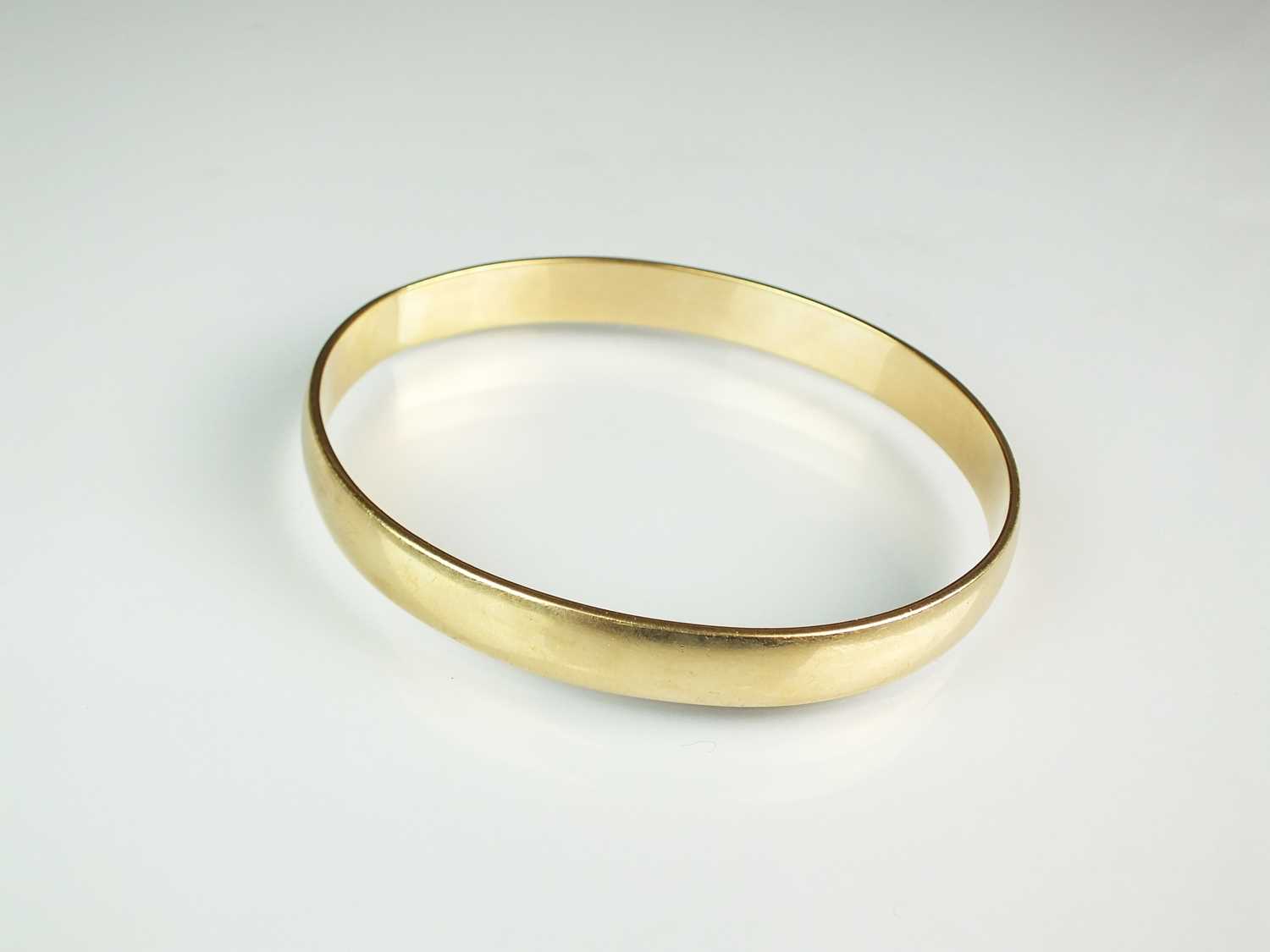 Lot 58 - A 9ct gold plain polished bangle