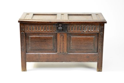 Lot 443 - A small 17th century oak coffer with a twin panelled top