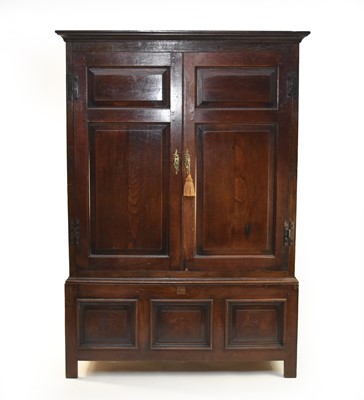 Lot 449 - An 18th century oak livery cupboard