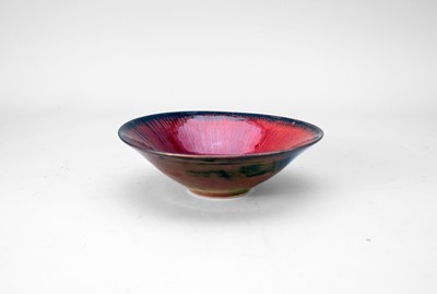 Lot 380 - Peter Sparrey (b.1967) a stoneware bowl with copper and red glaze