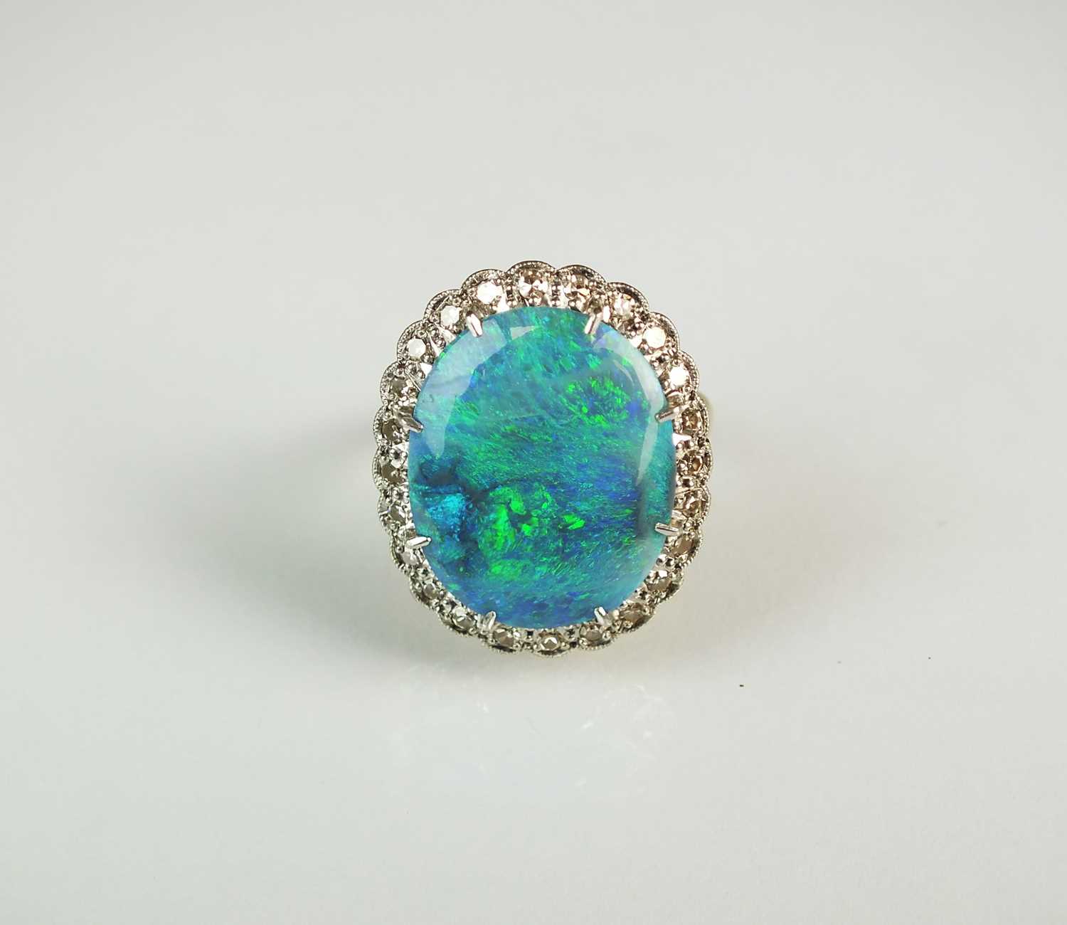 Lot 65 - An 18ct gold black opal and diamond cluster ring
