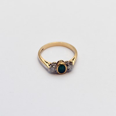 Lot 56 - An 18ct gold three stone emerald and diamond ring