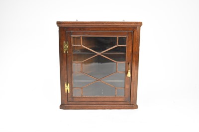 Lot 383 - A 19th century glazed oak hanging corner cupboard