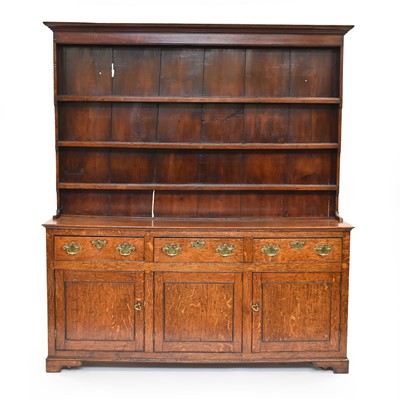Lot 623 - A George III oak dresser with rack