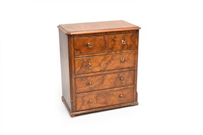 Lot 478 - A Victorian figured walnut miniature chest of 4 long drawers