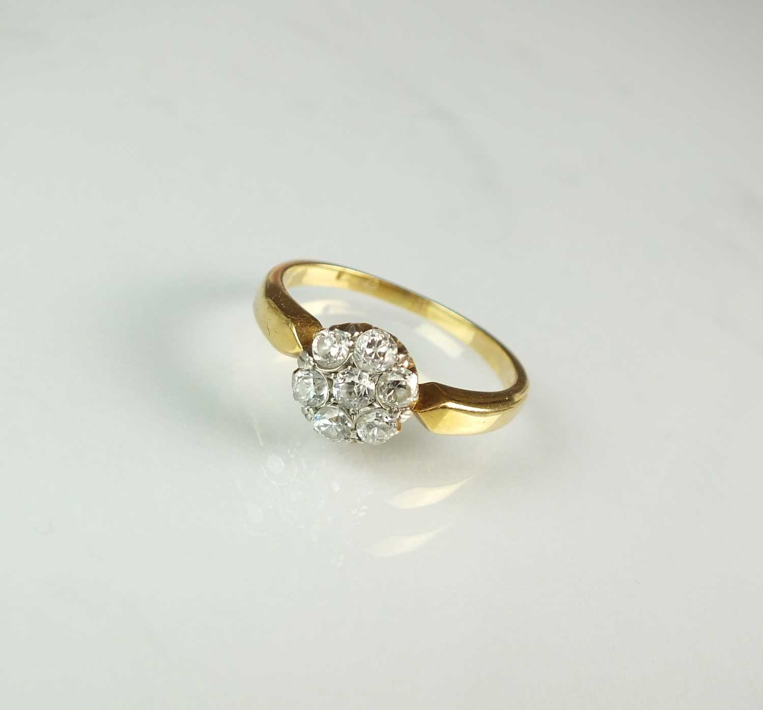 Lot 262 - A seven stone diamond floral cluster ring