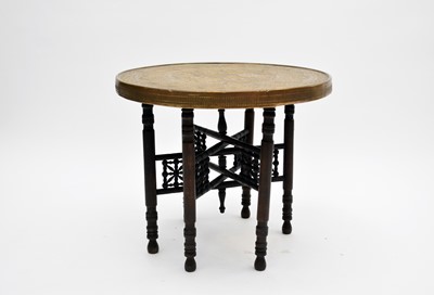 Lot 489 - A Near Eastern brass topped folding occasional table