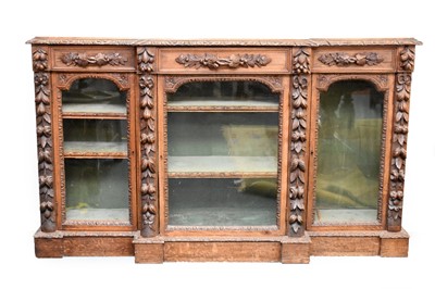 Lot 506 - A Victorian carved oak breakfront glazed bookcase