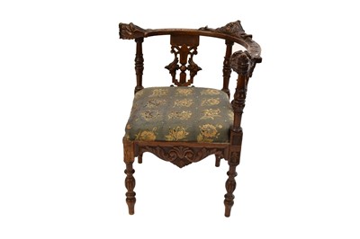 Lot 466 - A 19th century Flemish style carved oak upholstered elbow chair