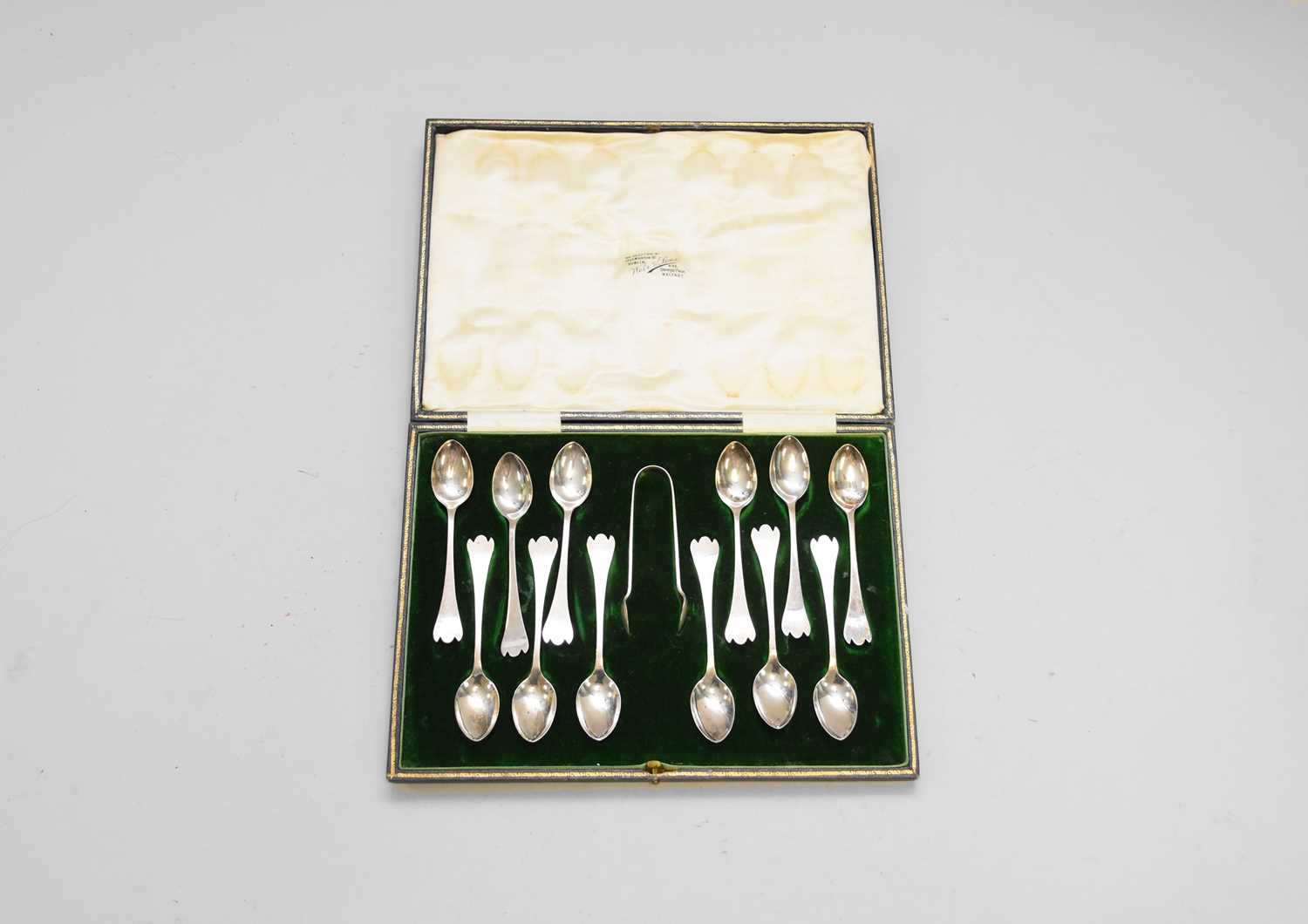 Lot 8 - A cased set of twelve stylised trefid silver teapsoons with sugar tongs