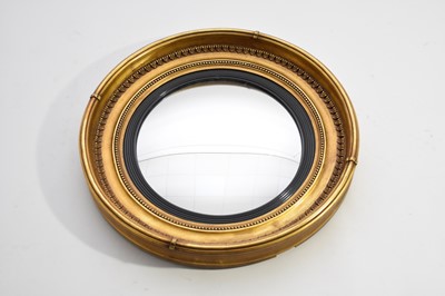 Lot 412 - A 19th century giltwood convex mirror