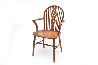 Lot 776 - A 19th century yew and elm wheel-back Windsor armchair