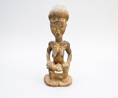 Lot 229 - A Baule tribal carved wood seated female, Ivory Coast, West Africa