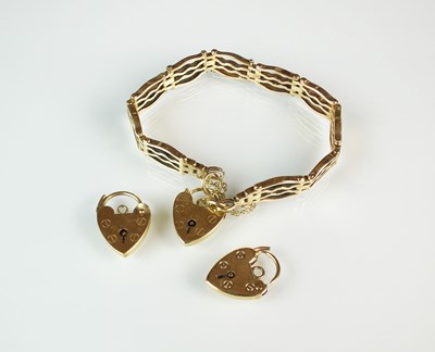 Lot 123 - A yellow metal bracelet and two clasps