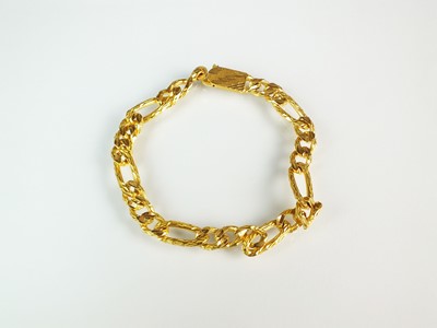 Lot 64 - A yellow metal textured curb link bracelet