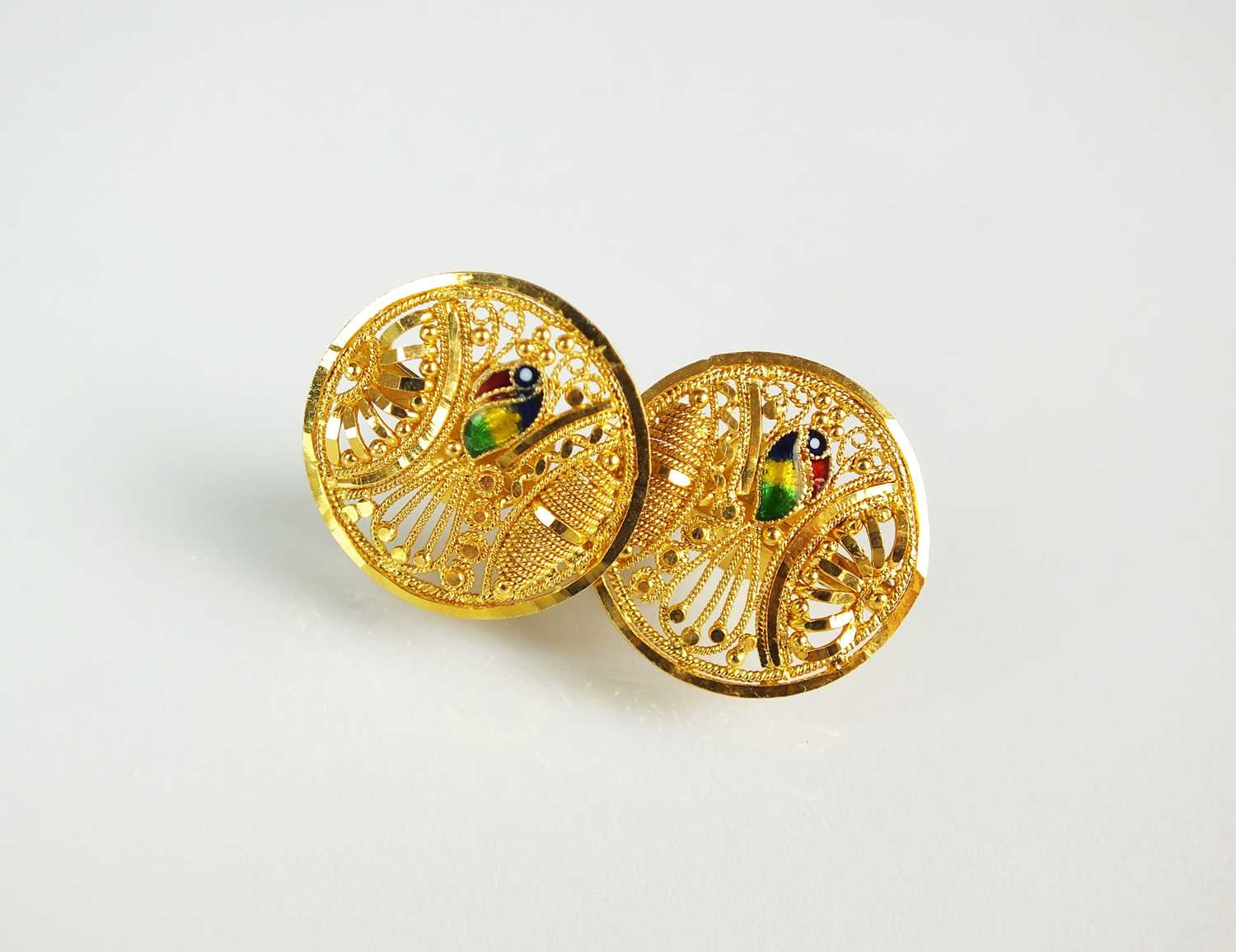Lot 85 - A pair of yellow metal and enamel earrings