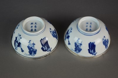 Lot 27 - A pair of Chinese blue and white 'immortals' bowls, Kangxi marks and period