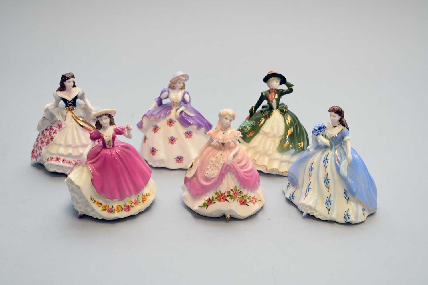 Lot 544 - A set of six Coalport miniature 'Fairest Flowers' ladies