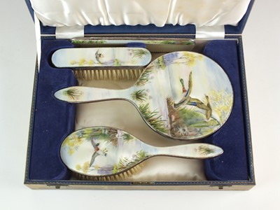 Lot 10 - A cased silver and enamel dressing table set