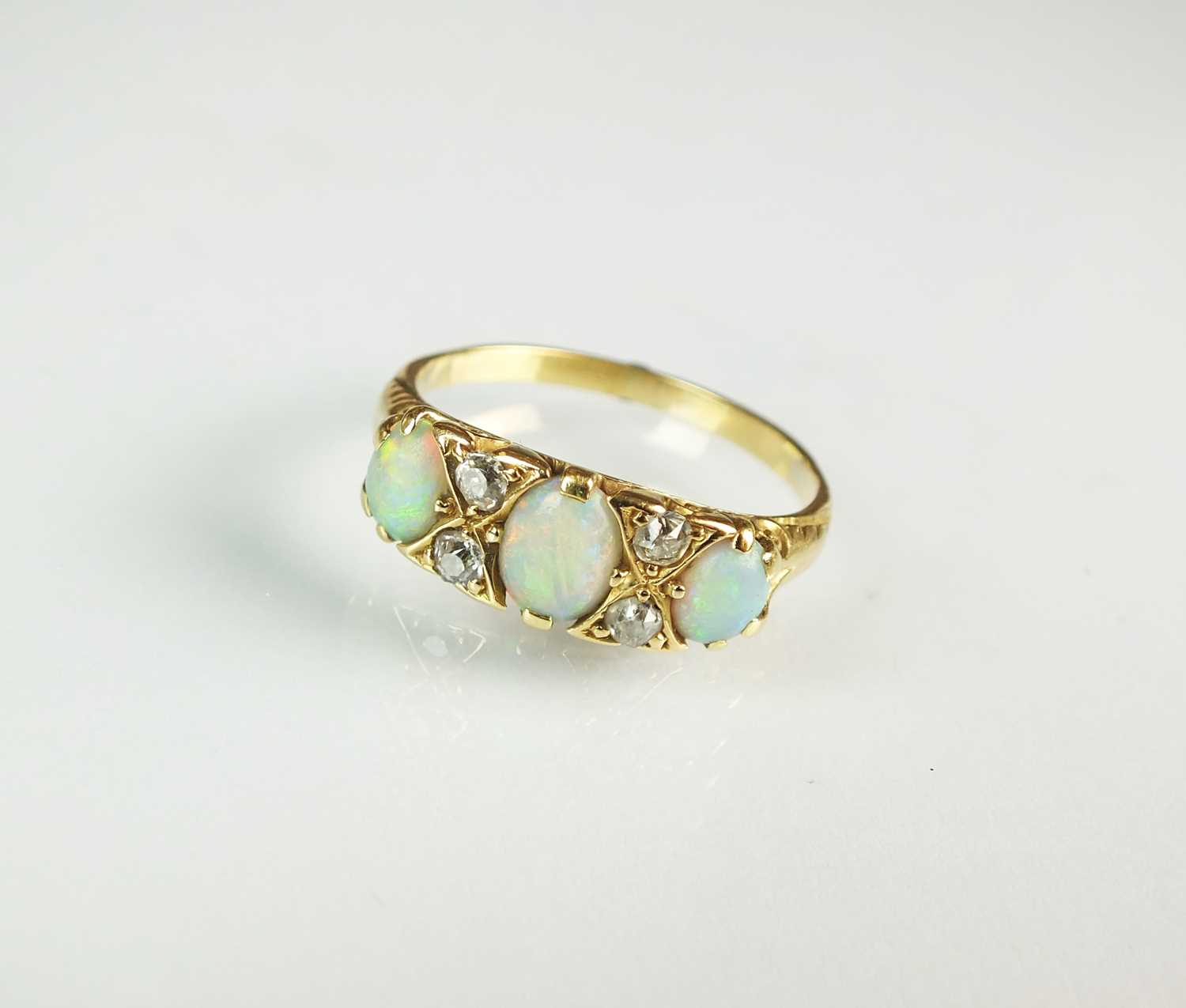 Lot 67 - A seven stone opal and diamond ring
