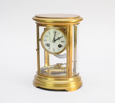 Lot 299 - A 20th century oval brass four glass clock