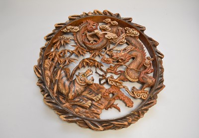 Lot 648 - A South East Asian carved sandalwood roundel