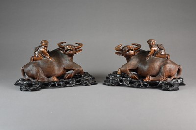 Lot 619 - A pair of Chinese carved root wood figures of boys on buffalos