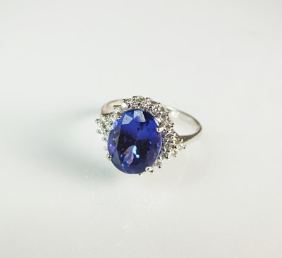 Lot 100 - An 18ct white gold tanzanite and diamond cluster ring