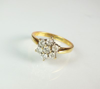 Lot 130 - An 18ct gold seven stone diamond floral cluster ring