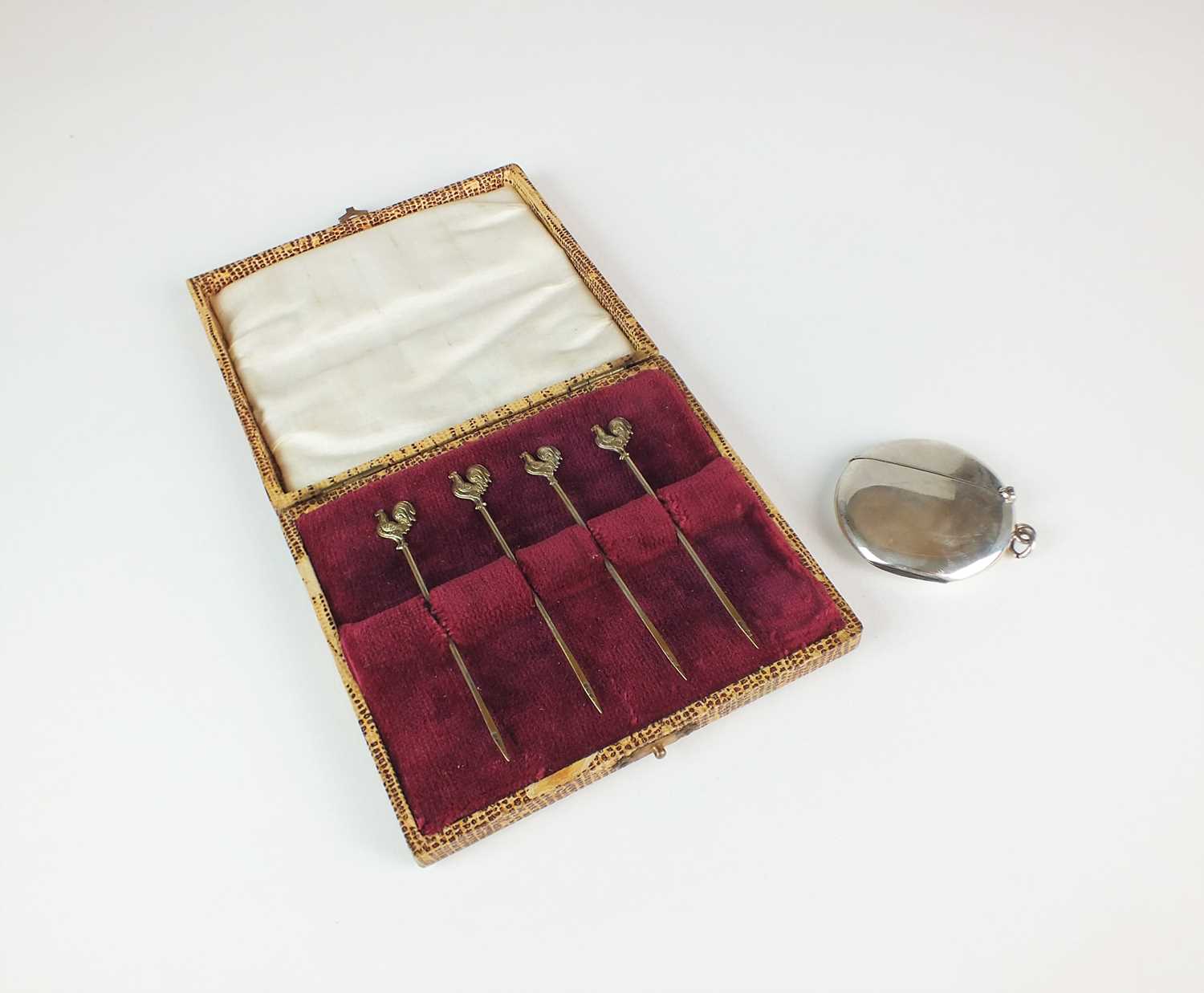 Lot 50 - A cased set of four silver gilt cocktail sticks and a silver vesta case