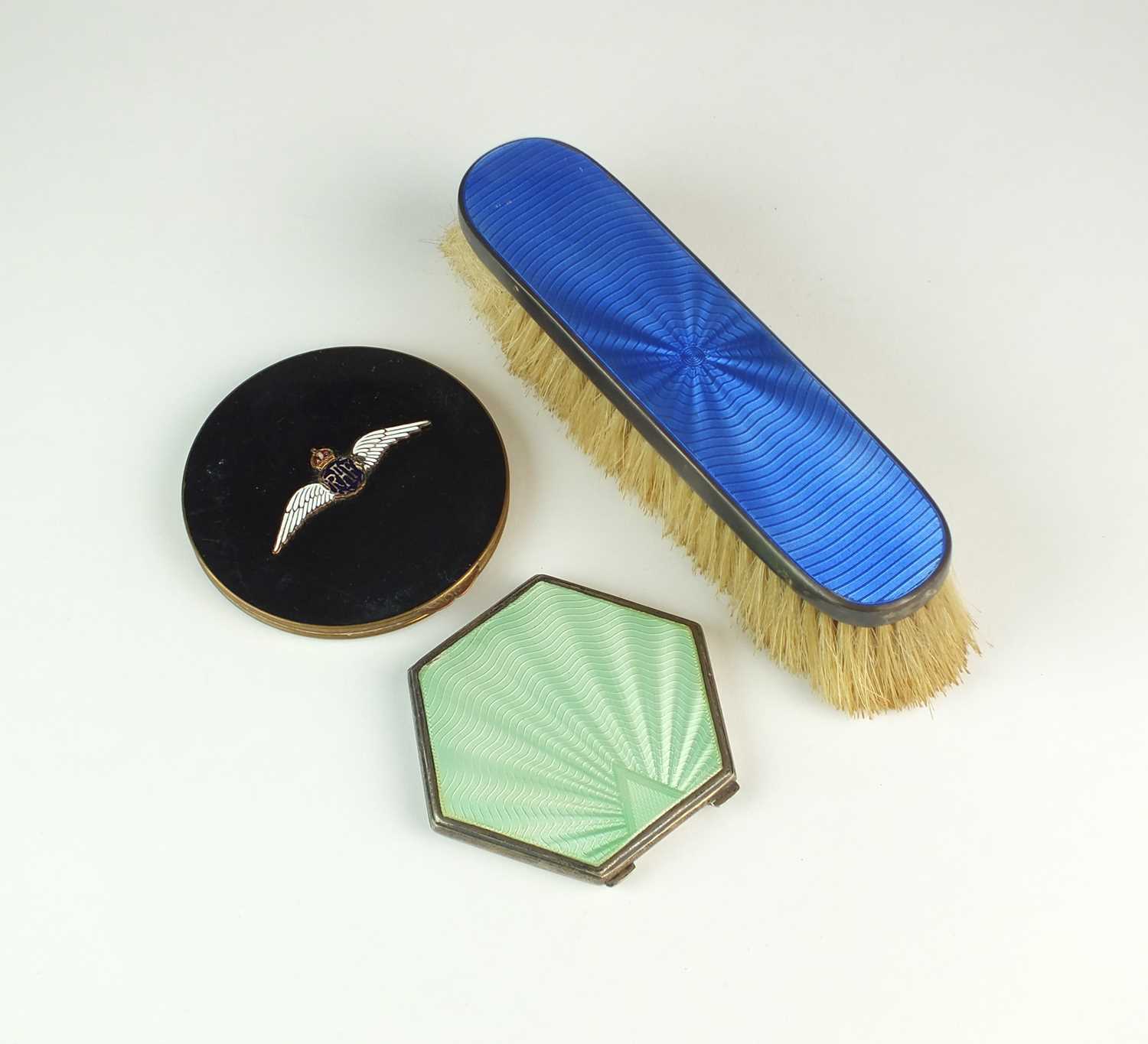 Lot 31 - Two compacts and a clothes brush