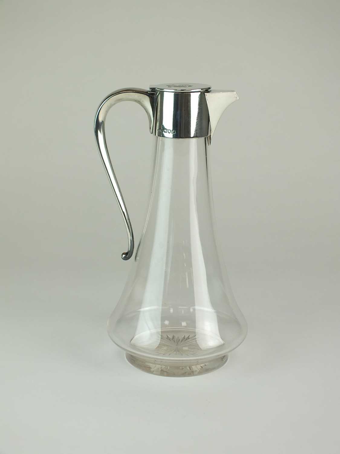 Lot 23 - An Edwardian silver mounted glass claret jug