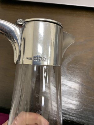 Lot 23 - An Edwardian silver mounted glass claret jug