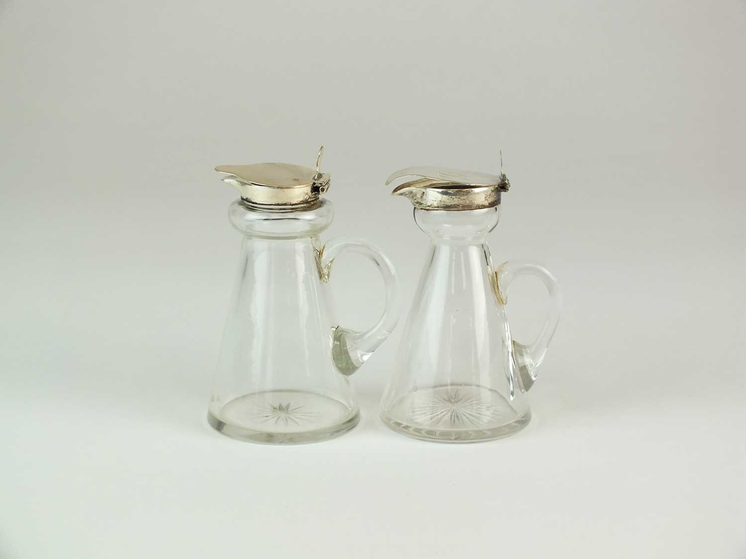 Lot 36 - Two silver topped whisky noggins