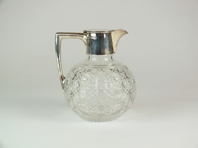 Lot 46 - A late Victorian silver mounted glass claret jug