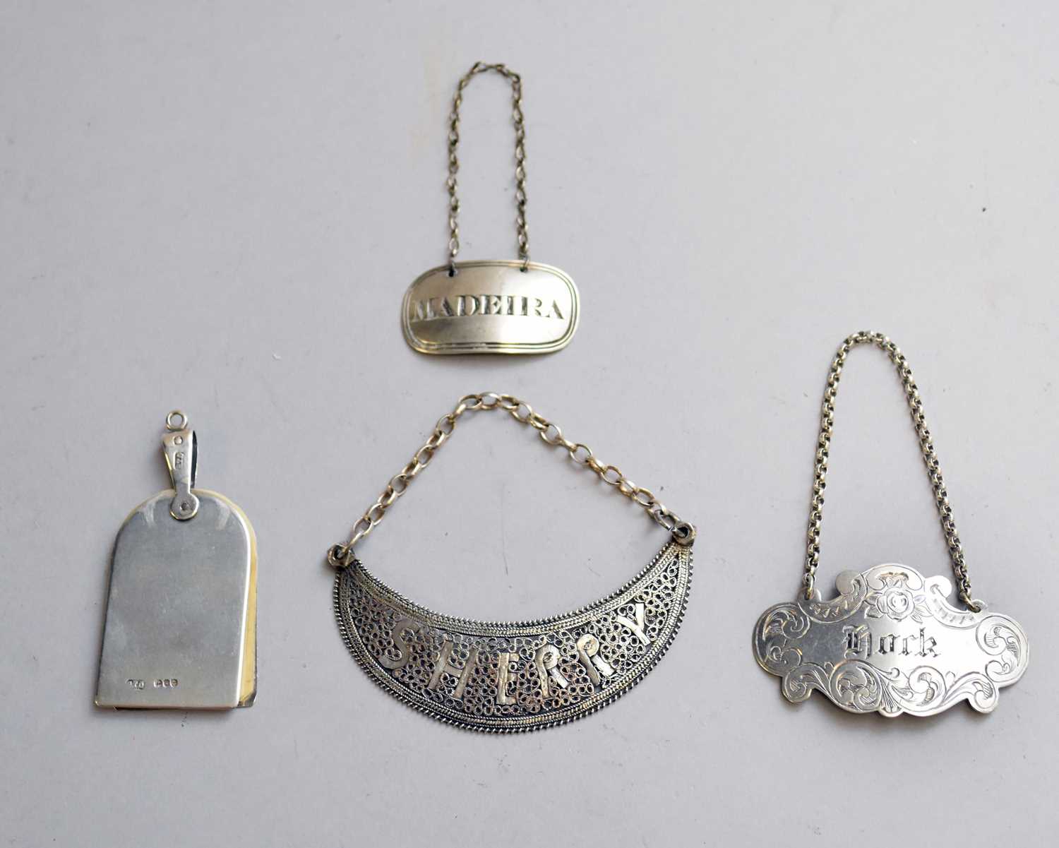 Lot 5 - A silver aide memoire and decanter labels