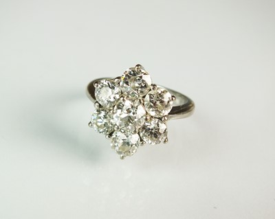 Lot 82 - An 18ct white gold seven stone diamond floral cluster ring
