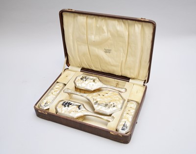 Lot 219 - An Art Deco cased silver and simulated mother of pearl mounted dressing table set