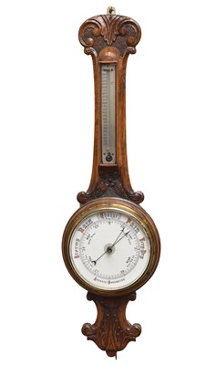 Lot 745 - A late Victorian carved oak aneroid 'banjo' barometer